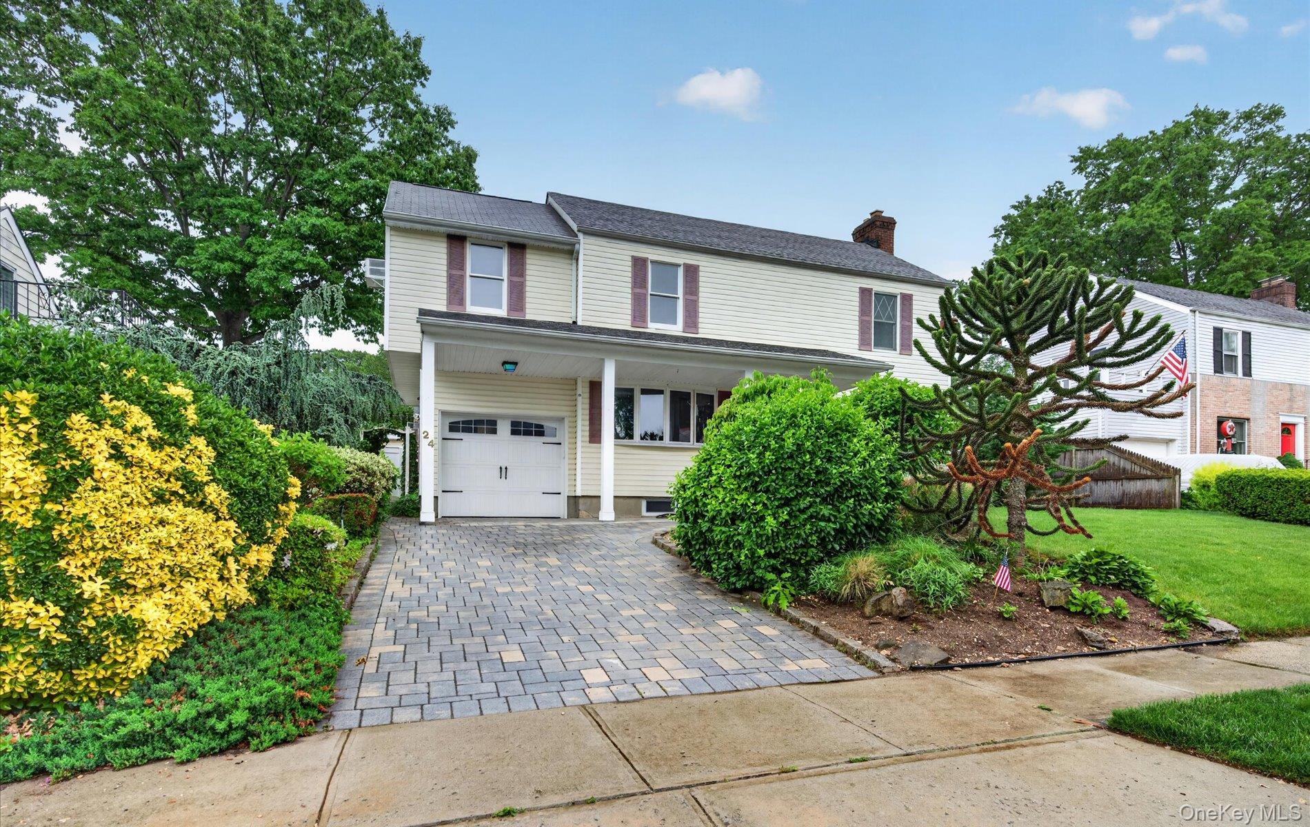 a front view of a house with a garden