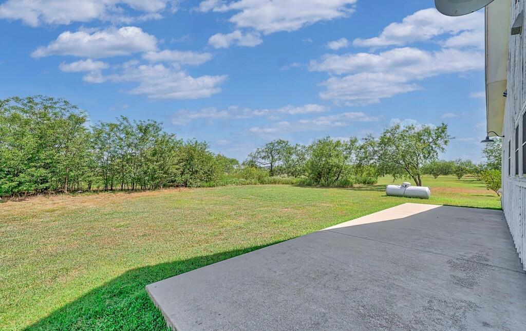 109 Springfield Lane Waco, TX 76705 - Photo 35 of 39 View of green lawn featuring a patio