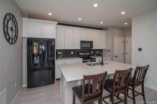 a kitchen with stainless steel appliances a refrigerator stove microwave and cabinets