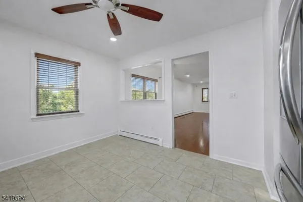 an empty room with windows and closet