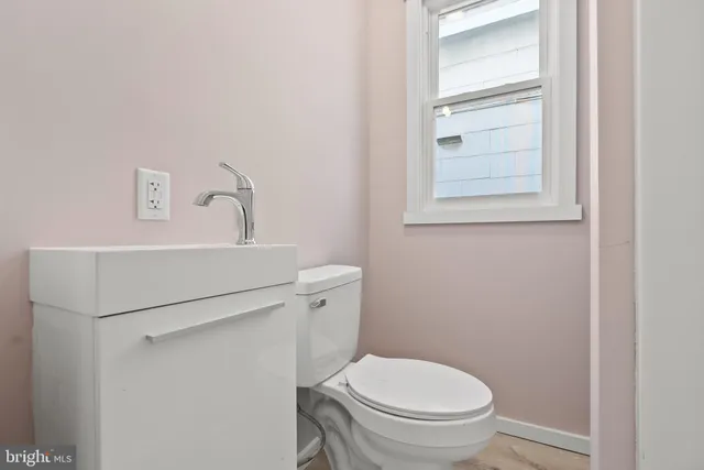 a white toilet sitting next to a bathroom sink