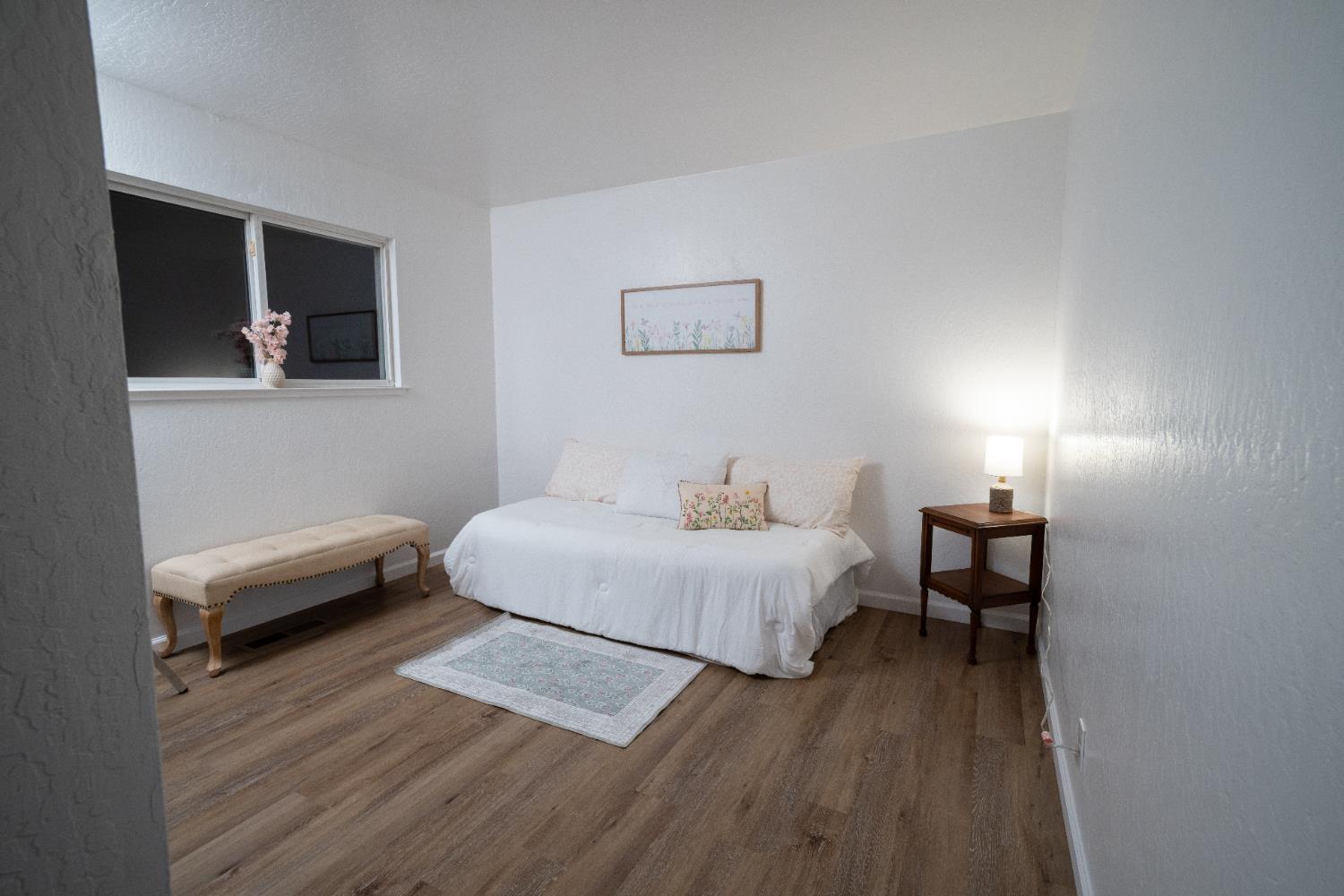 6100 Shasta Road Garden Valley, CA 95633 - Photo 25 of 39 a bedroom with a bed and a wooden floor