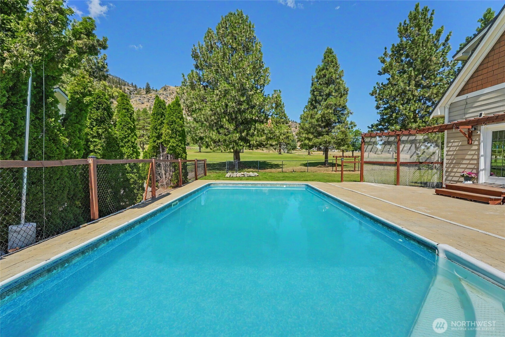 93 Golf Course Drive Pateros, WA 98846 - Photo 22 of 34 a view of a backyard with swimming pool