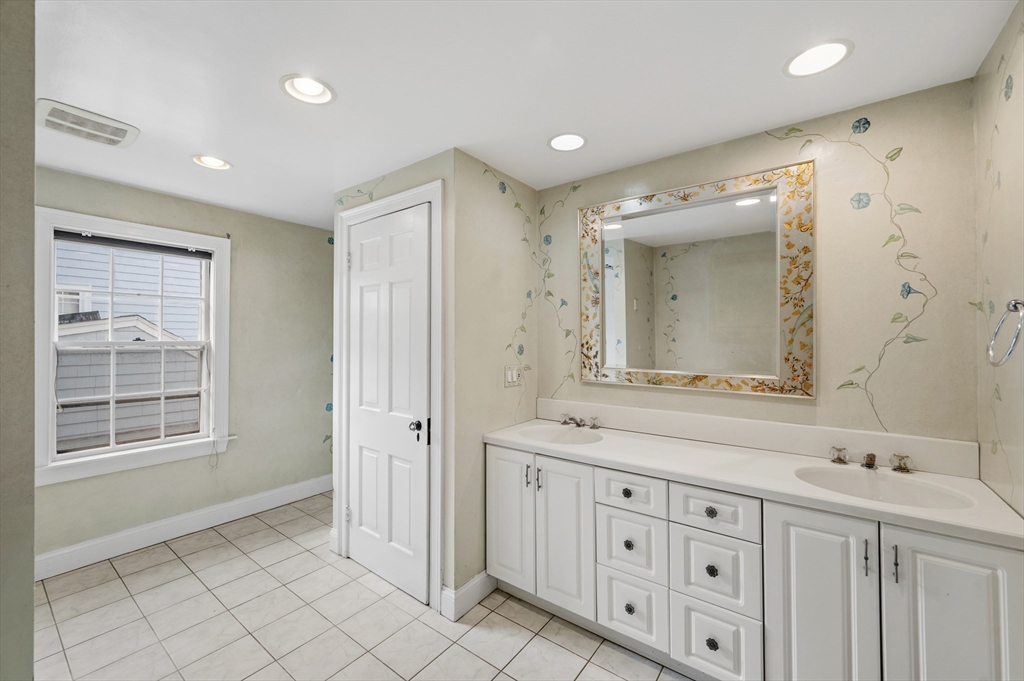 26 Pickwick Road Marblehead, MA 01945 - Photo 25 of 40 a spacious bathroom with a double vanity sink a mirror and a bathtub