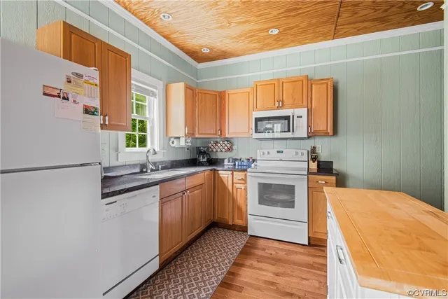 a kitchen with stainless steel appliances a stove a sink and a refrigerator