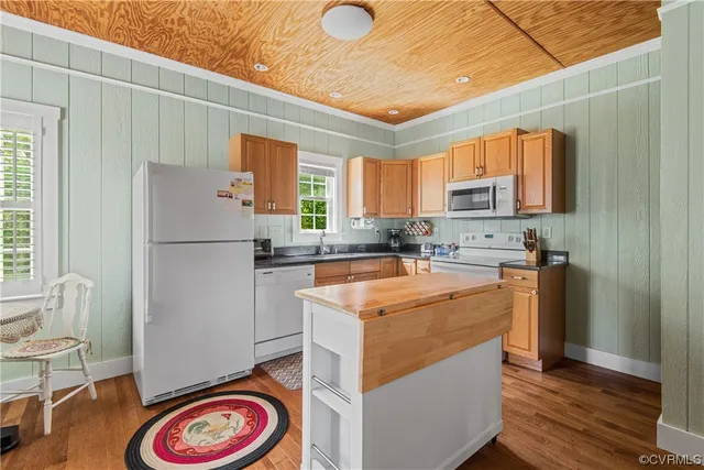 a kitchen with stainless steel appliances granite countertop a sink and a refrigerator