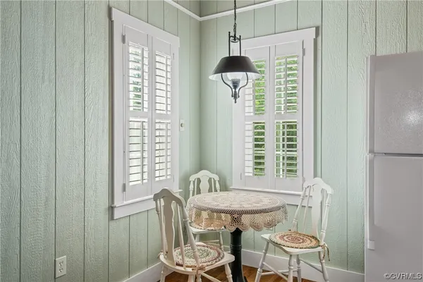a dining room with furniture and wooden floor