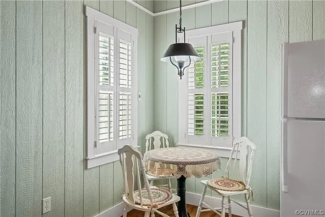 a dining room with furniture and wooden floor