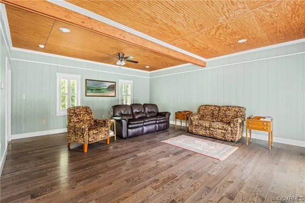 a view of a livingroom with furniture and hardwood floor