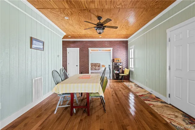 a kitchen with stainless steel appliances a table and chairs
