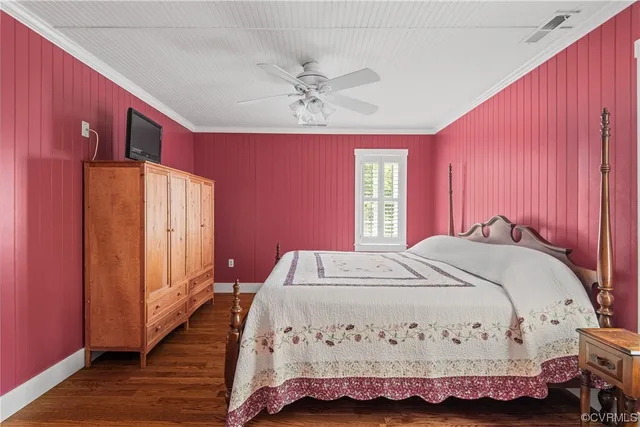 a bed sitting in a spacious bedroom next to a window