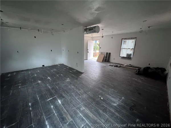 a bathroom with a granite countertop sink a toilet a mirror and shower