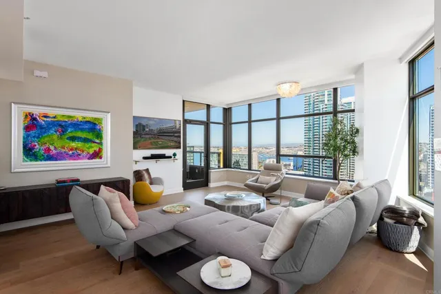 a living room with furniture a large window and a flat screen tv