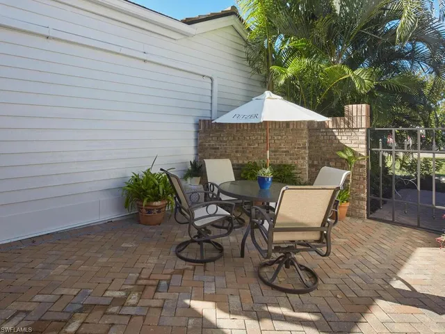 a backyard of a house with table and chairs
