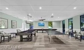 a living room with furniture a large window and a table