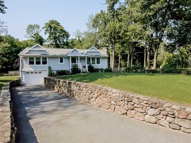 5 Archer Lane Darien, CT 06820 - Photo 15 of 17 a front view of a house with a garden