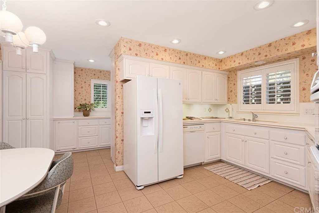 625 Rosemarie Drive Arcadia, CA 91007 - Photo 11 of 35 a kitchen with a refrigerator and white cabinets