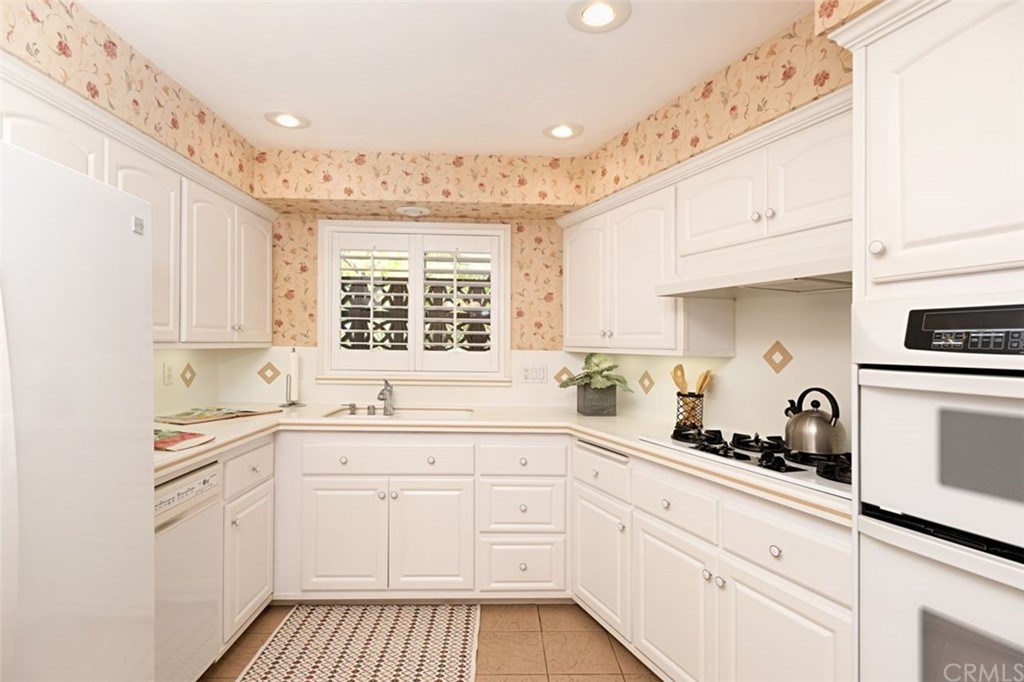 625 Rosemarie Drive Arcadia, CA 91007 - Photo 12 of 35 a kitchen with granite countertop white cabinets and white appliances