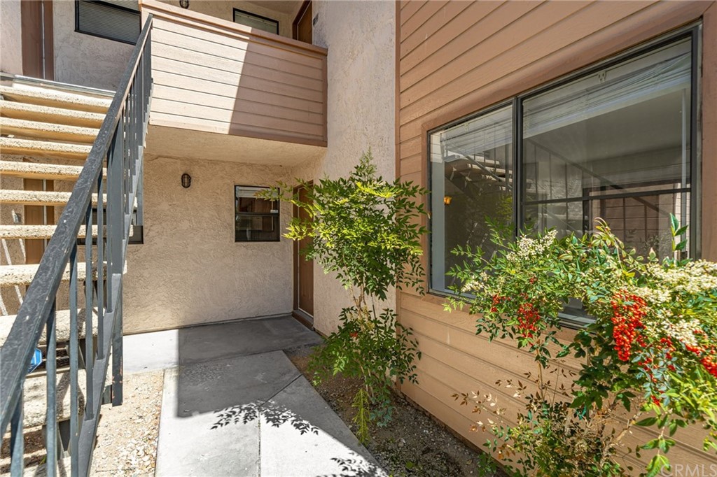 1327 Massachusetts Avenue, Unit 102 Riverside, CA 92507 - Photo 1 of 1 a potted plant sitting in front of a house