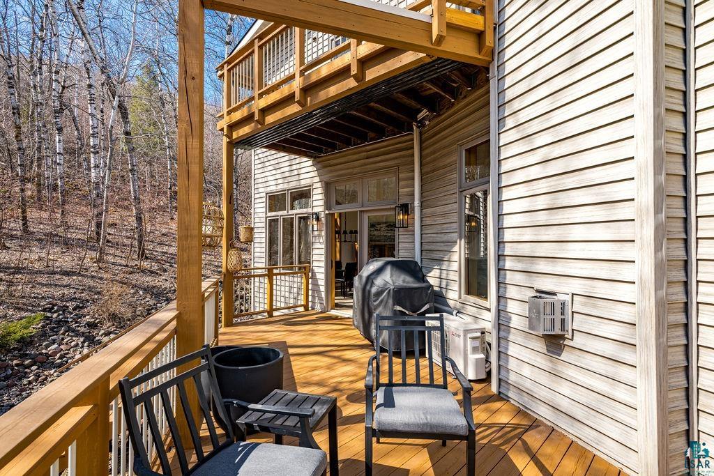 4856 Kingston Street Duluth, MN 55804 - Photo 53 of 88 Multi-level wood deck featuring light-toned wood siding, a recessed lower deck area, and an upper deck with wood railings