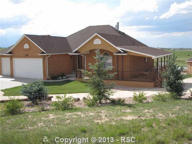 15028 Herring Road Colorado Springs, CO 80908 - Photo 1 of 17 Stucco exterior, 3 car attached & 3 car detached, wrap around deck!