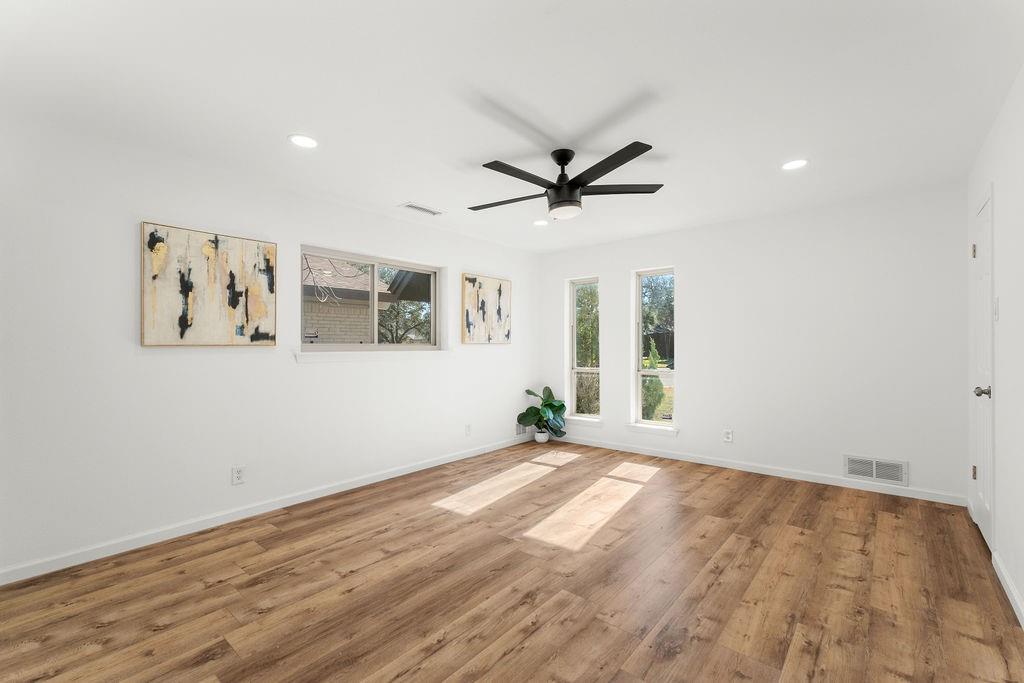 11022 Ferndale Road Dallas, TX 75238 - Photo 13 of 37 a view of a big room with wooden floor and windows