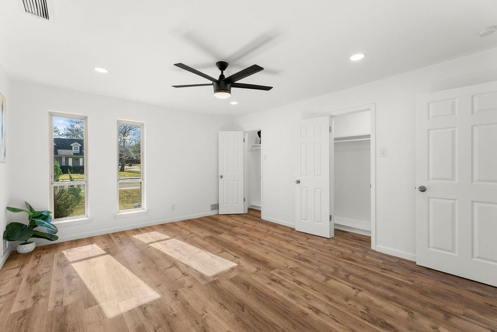 11022 Ferndale Road Dallas, TX 75238 - Photo 15 of 37 a view of a livingroom with wooden floor and a ceiling fan