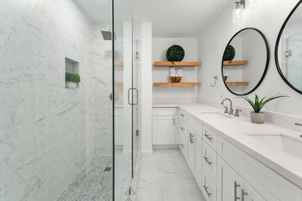 11022 Ferndale Road Dallas, TX 75238 - Photo 16 of 37 a bathroom with a double vanity sink a mirror and shower