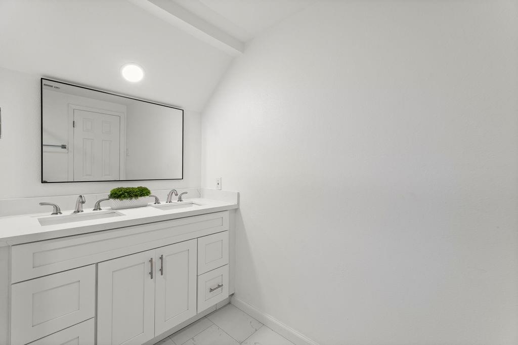 11022 Ferndale Road Dallas, TX 75238 - Photo 22 of 37 a bathroom with a sink and a mirror