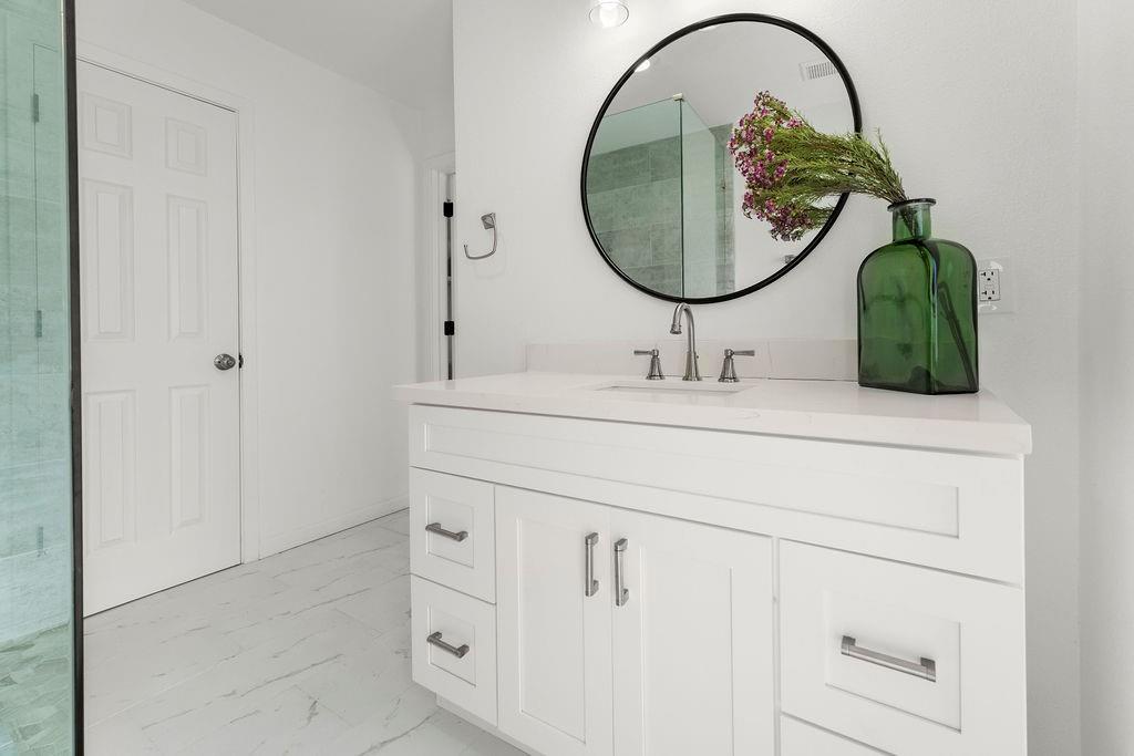 11022 Ferndale Road Dallas, TX 75238 - Photo 23 of 37 a bathroom with a sink and a mirror