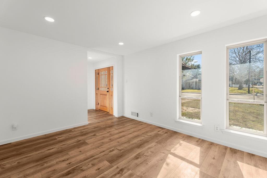 11022 Ferndale Road Dallas, TX 75238 - Photo 25 of 37 a view of an empty room with wooden floor and a window