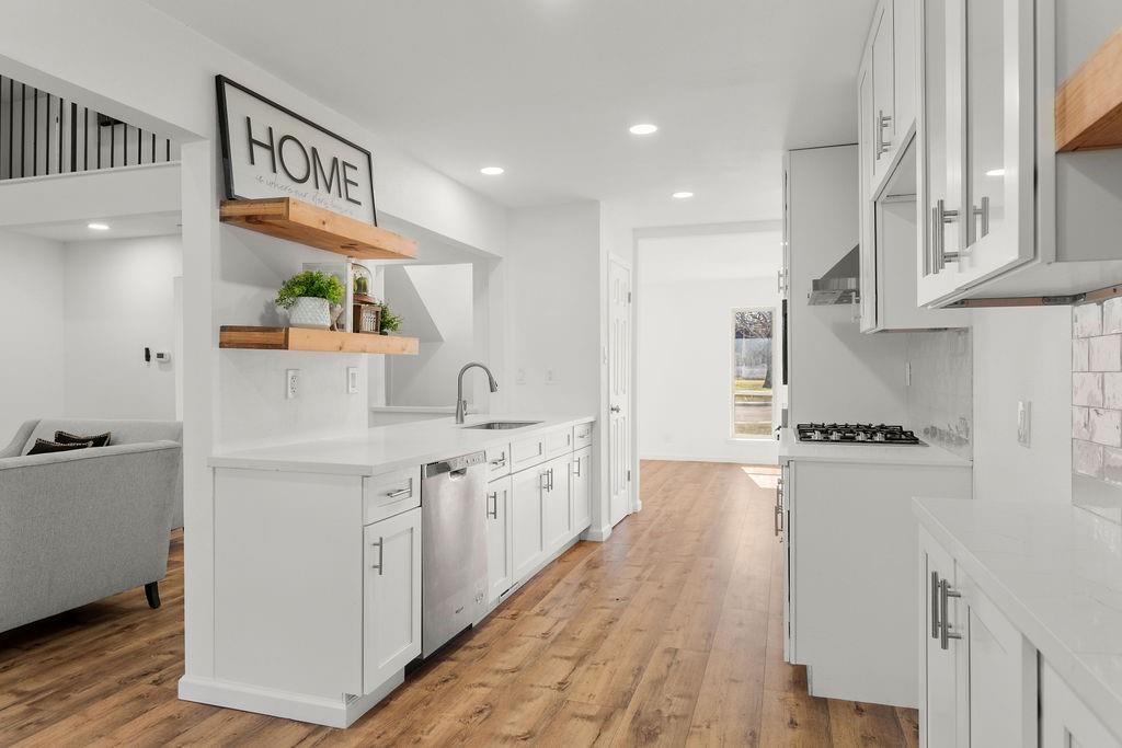 11022 Ferndale Road Dallas, TX 75238 - Photo 8 of 37 a kitchen with stainless steel appliances granite countertop a refrigerator a stove and a wooden floors