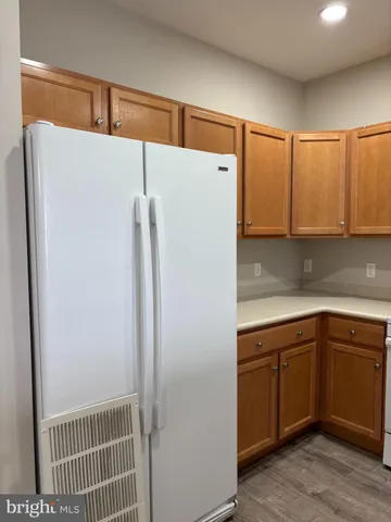 a kitchen with a refrigerator and cabinets