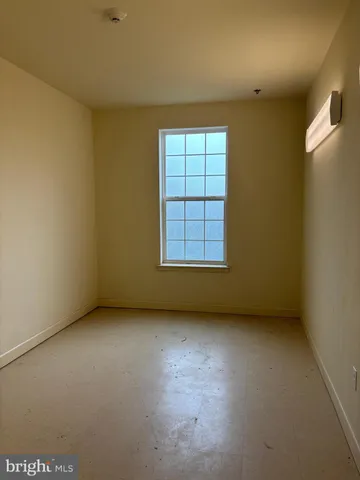 an empty room with a empty space and windows