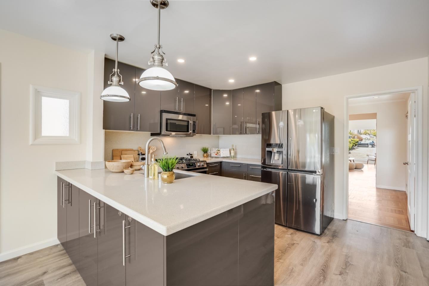 49 Sheffield Drive Daly City, CA 94015 - Photo 17 of 55 a kitchen with refrigerator cabinets and wooden floor
