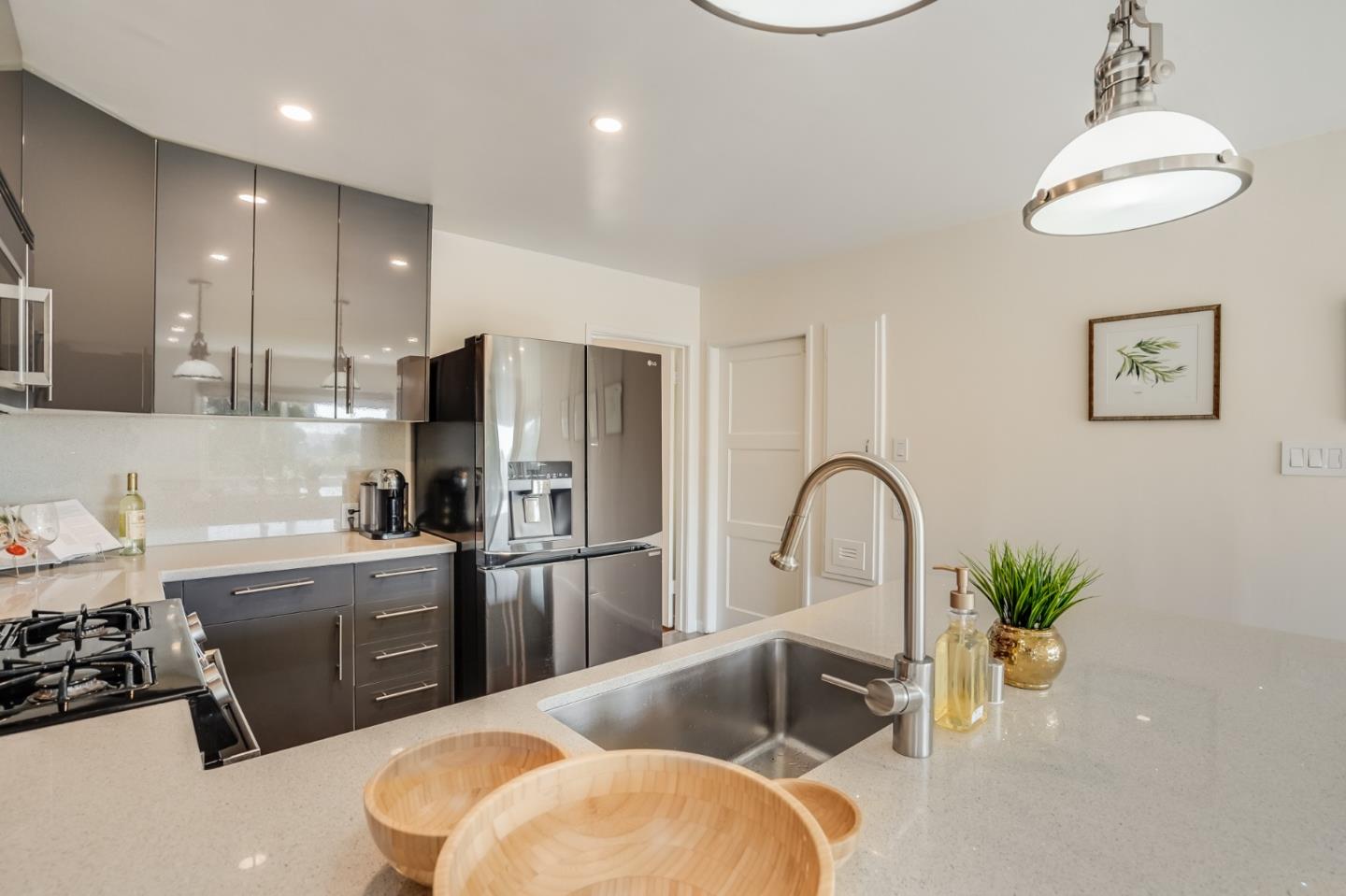 49 Sheffield Drive Daly City, CA 94015 - Photo 19 of 55 a kitchen with stainless steel appliances granite countertop a refrigerator a sink a stove and a dining table with wooden floor