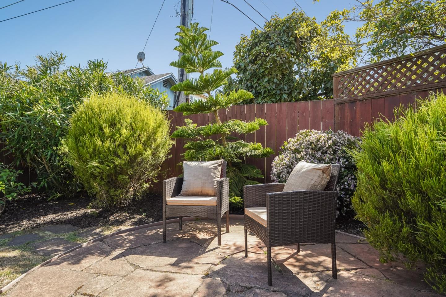 49 Sheffield Drive Daly City, CA 94015 - Photo 45 of 55 a backyard with table and chairs potted plants and wooden fence