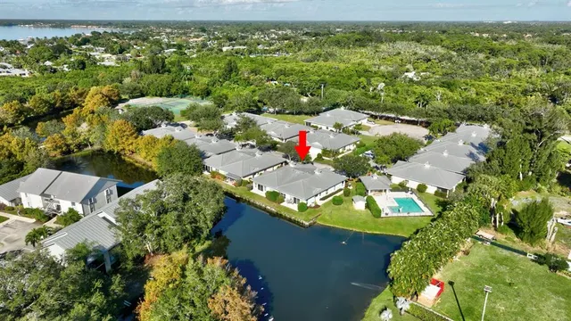 a view of a backyard with swimming pool and seating area