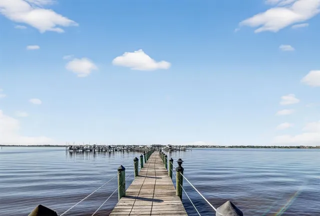 a view of a rooftop deck patio and outdoor dining space