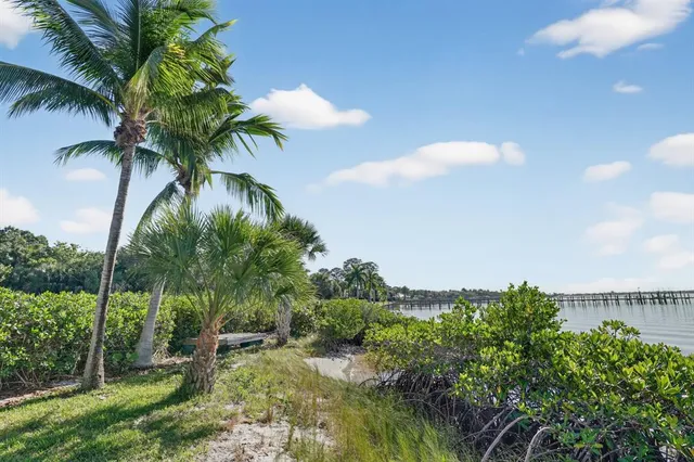 an aerial view of a house with a garden and lake view