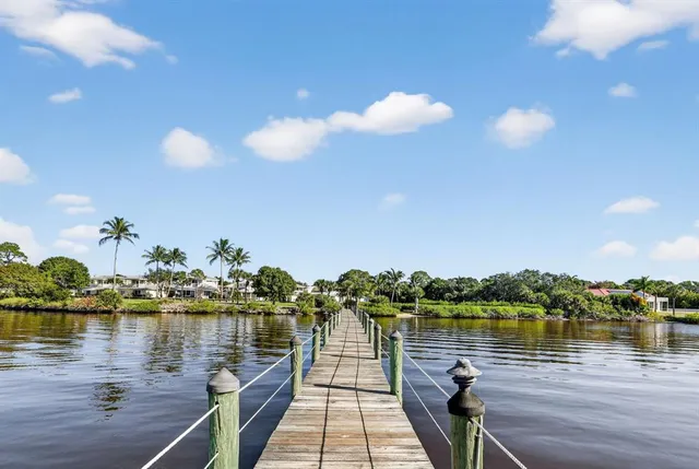 a front view of a house with a garden and garage