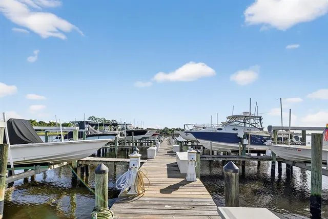 an aerial view of a city with lots of residential buildings and lake view