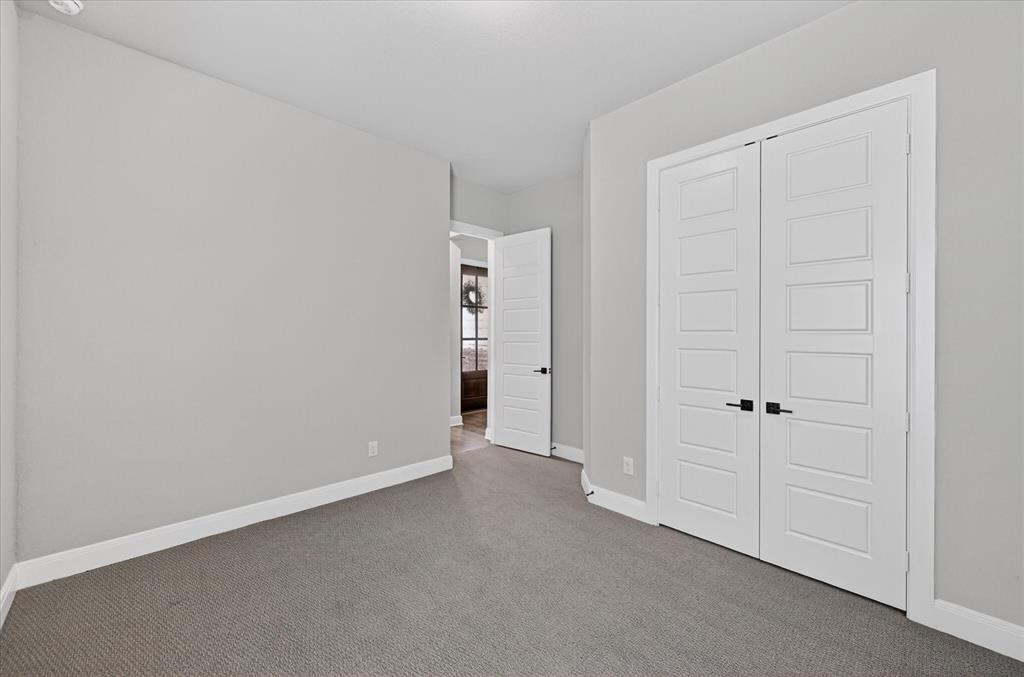 2237 Pika Road Northlake, TX 76247 - Photo 28 of 37 Room featuring light grey wall paint, plush grey carpeting, white baseboards, and white trim