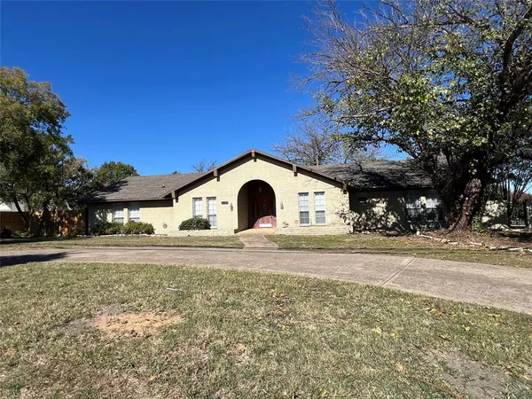 a large house with a large tree in front of it