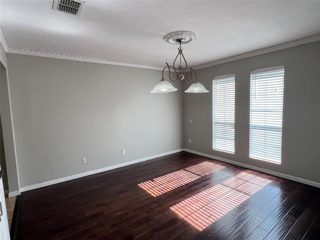 6151 Alpha Road Dallas, TX 75240 - Photo 15 of 39 a view of an empty room with a window and wooden floor