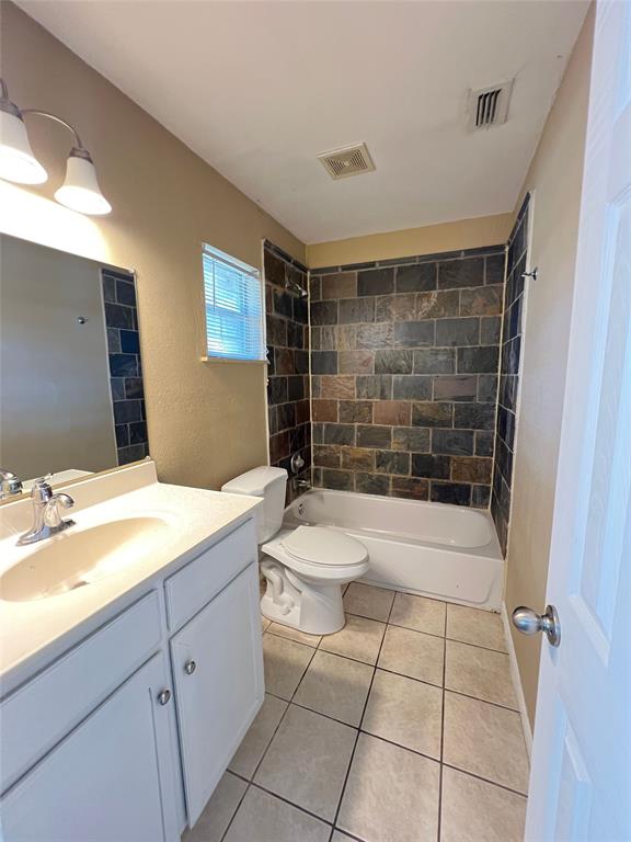 6151 Alpha Road Dallas, TX 75240 - Photo 21 of 39 a bathroom with a sink a toilet and shower