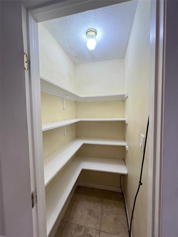 6151 Alpha Road Dallas, TX 75240 - Photo 22 of 39 a storage room with empty racks