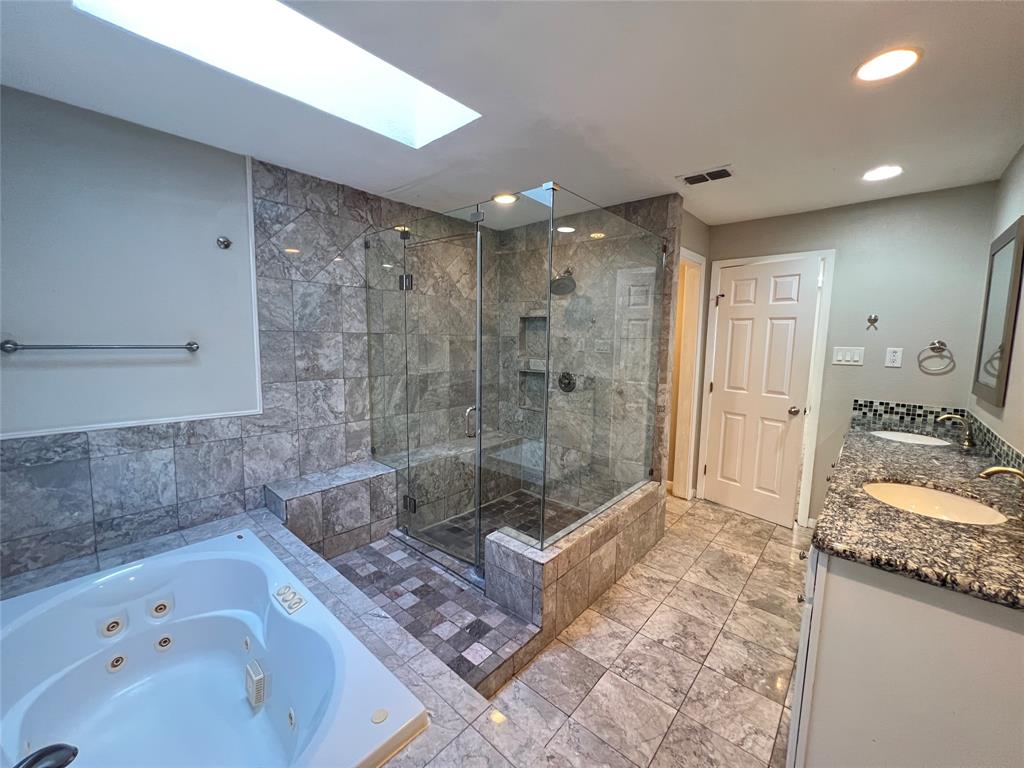 6151 Alpha Road Dallas, TX 75240 - Photo 35 of 39 a bathroom with a tub a sink and glass door