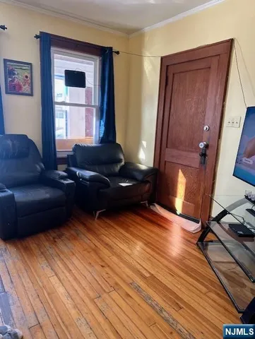 a living room with furniture and a mirror