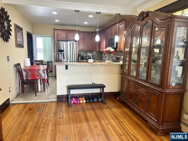 a kitchen with stainless steel appliances granite countertop a sink dishwasher microwave stove and refrigerator